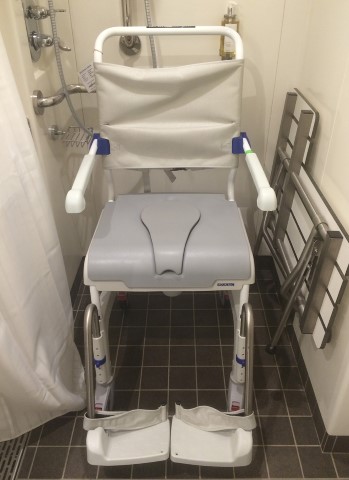 Mobile commode in cabin bathroom with foot rests